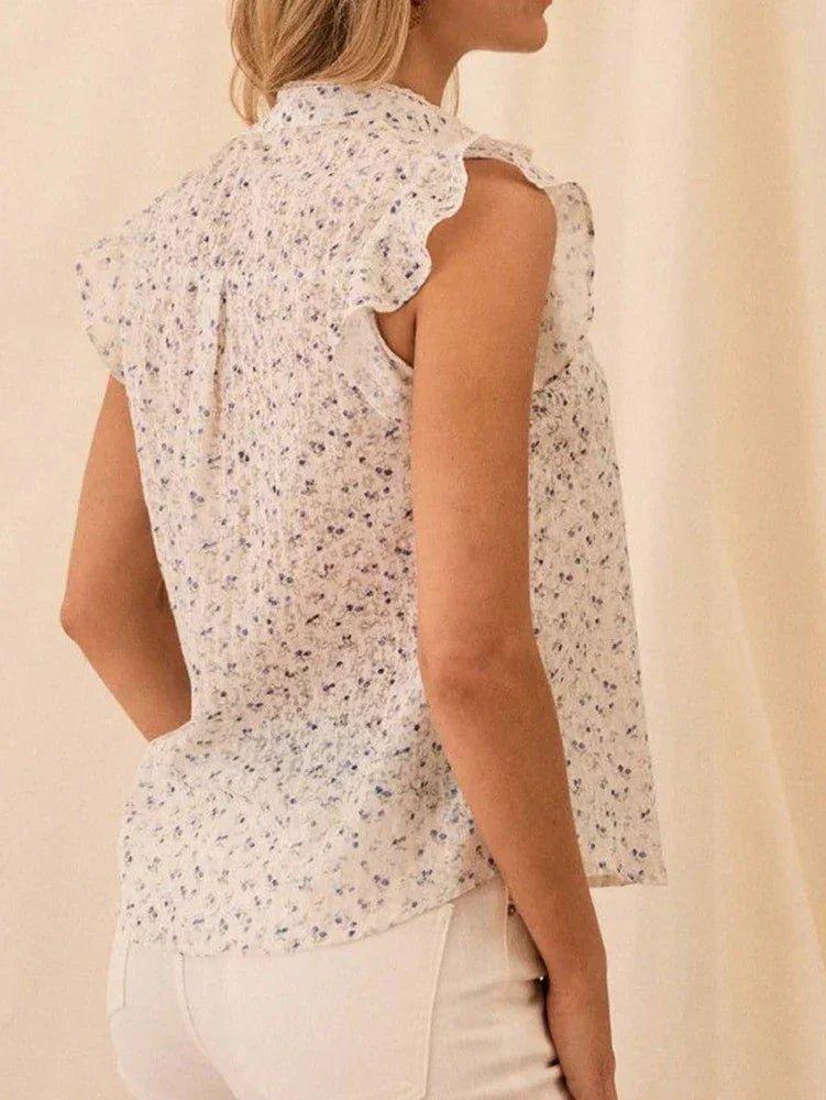 Women's floral sleeveless blouse with ruffled collar and back detail, perfect for spring fashion