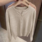Beige women's button-front knit sweater on hanger, soft texture, casual fashion