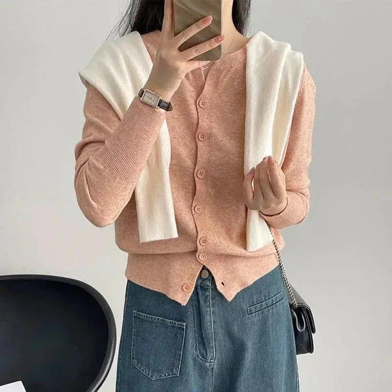 Pink cardigan with white accents, paired with denim skirt for women's fashion