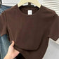 Brown women's cropped t-shirt on hanger, casual fashion top with round neck and short sleeves