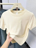 Cream cropped women's t-shirt on hanger, casual fashion top for summer outfits