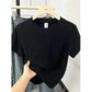 Black women's basic t-shirt on hanger, casual fashion top for everyday wear