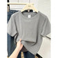 Gray women's oversized t-shirt on hanger, casual fashion top with relaxed fit