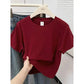 Burgundy women's crop top t-shirt on hanger with jeans, casual fashion