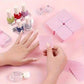 Pink nail polish remover pads with nail polish bottles on pink background, beauty and fashion essentials
