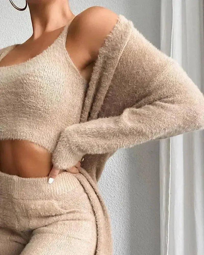 Woman in cozy beige knit crop top and matching pants, off-shoulder style, fashion outfit