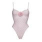 Pink polka dot one-piece swimsuit with floral accent, women's fashion swimwear