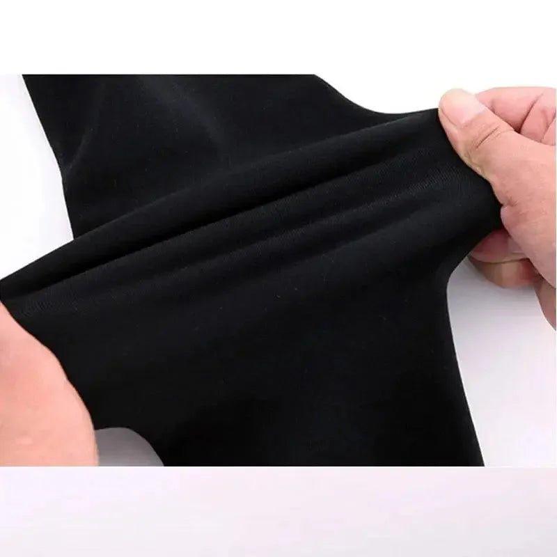 Black stretchy fabric being stretched by hands, ideal for women's fashion apparel