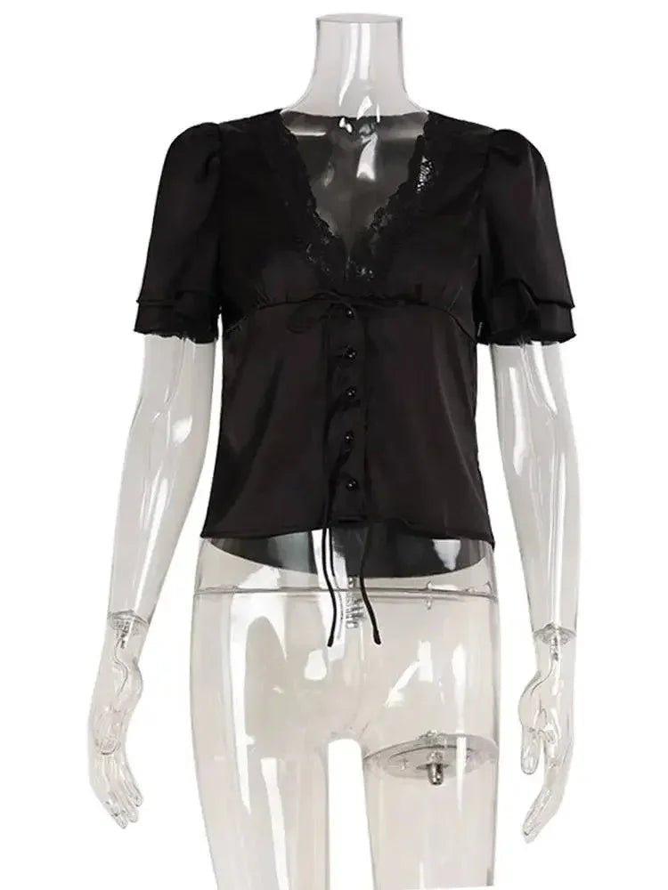 Black lace-trimmed blouse with puff sleeves and front buttons on mannequin