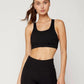 Woman in black sports bra and high-waist leggings, fitness activewear for gym or yoga