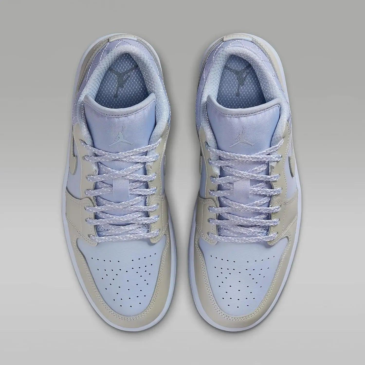 Light blue and beige women's Jordan sneakers with white laces and perforated toe box