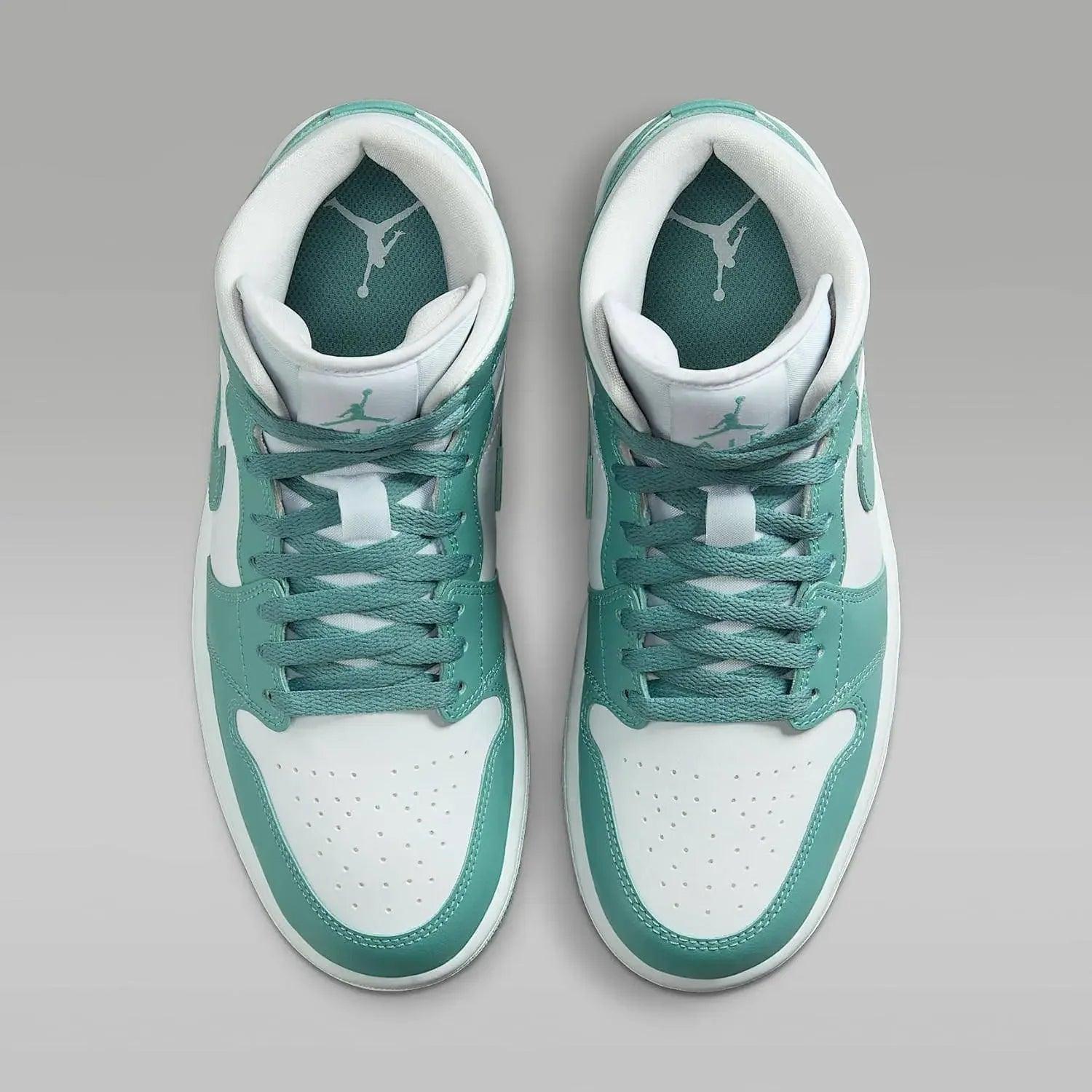Teal and white high-top sneakers with Jumpman logo, perfect for women's fashion and streetwear style