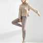Woman in beige cropped hoodie and gray joggers, stylish athleisure outfit for casual wear