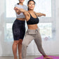 Women in activewear doing yoga pose on purple mat, fitness fashion