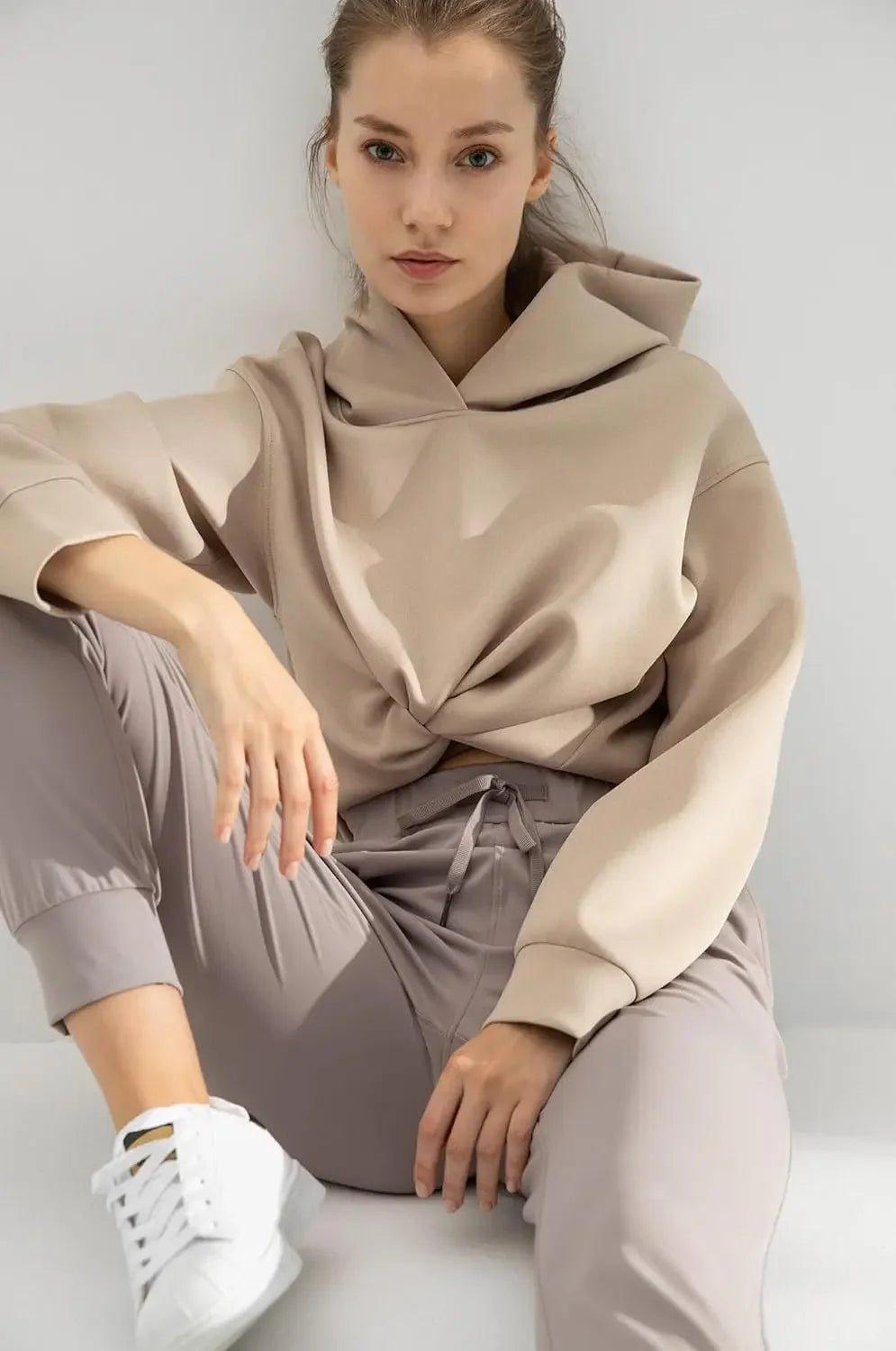 Woman in beige oversized hoodie and matching joggers, casual fashion outfit