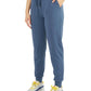 Blue women's jogger pants with drawstring waist, side pockets, and cuffed ankles, paired with colorful sneakers.