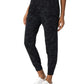 Black camo joggers for women, stylish casual pants with elastic waist and cuffs, paired with white sneakers