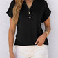 Black V-neck button-up t-shirt with rolled sleeves, paired with white denim shorts for women's fashion