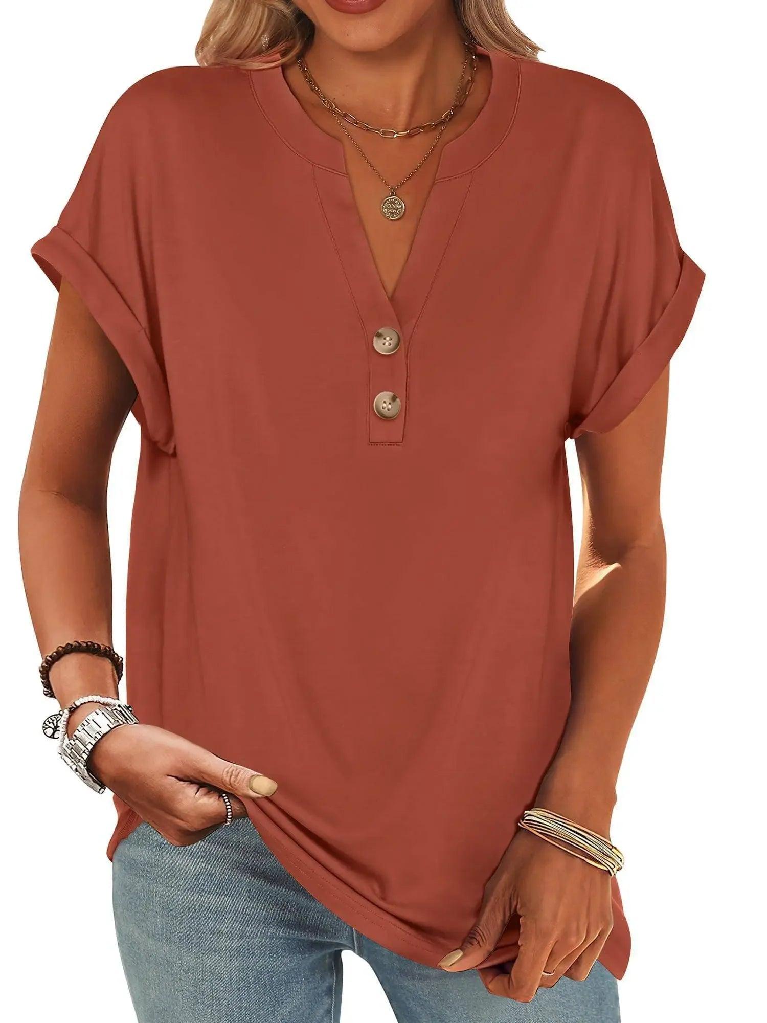 Rust-colored women's V-neck button-up t-shirt with rolled sleeves, paired with jeans and layered necklaces.