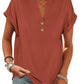 Rust-colored women's V-neck button-front t-shirt with rolled sleeves, paired with jeans and layered necklaces