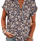 Women's navy floral print V-neck blouse with short sleeves and button front, paired with jeans