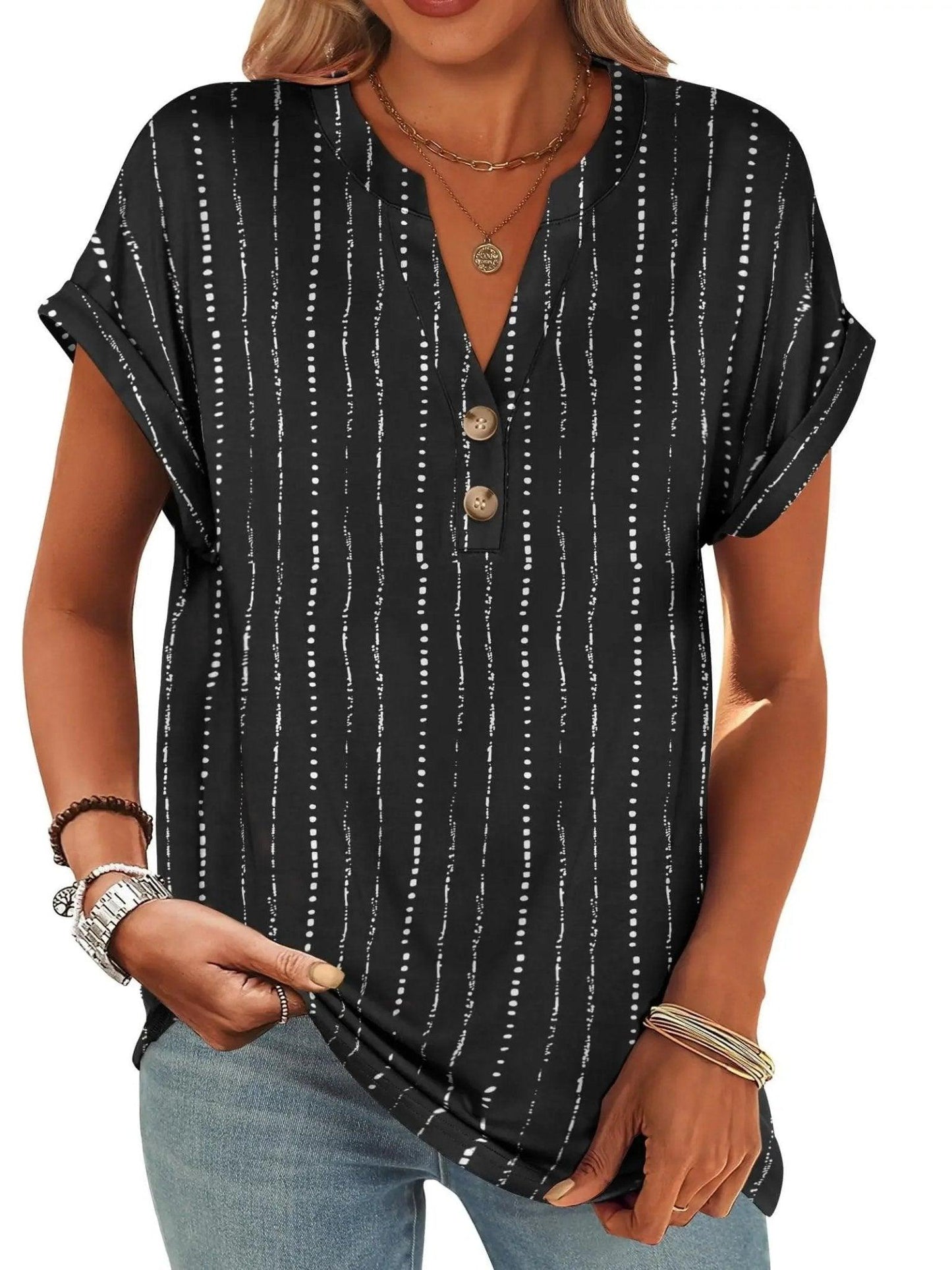 Black and white striped women's V-neck button-up top with rolled sleeves, paired with jeans and layered necklaces