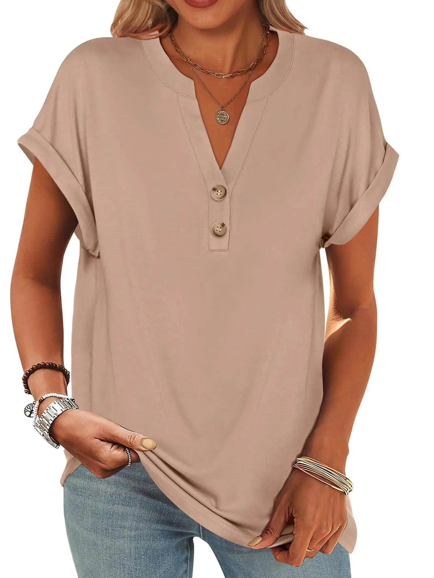 Beige women's V-neck button-up t-shirt with rolled sleeves, paired with jeans and layered necklaces for casual fashion.