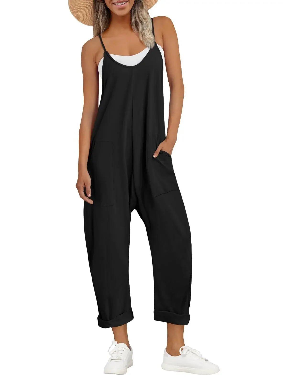 Black women's jumpsuit with pockets, paired with white sneakers and straw hat for casual fashion
