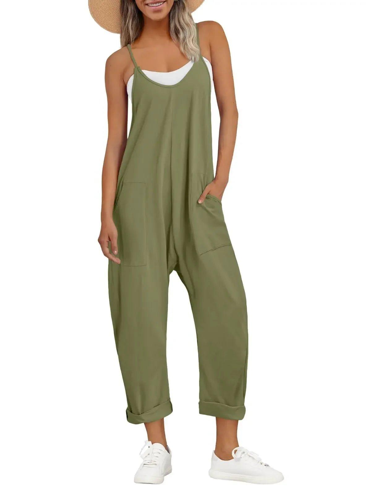 Olive green women's jumpsuit with pockets, paired with white sneakers and a straw hat for casual summer fashion.