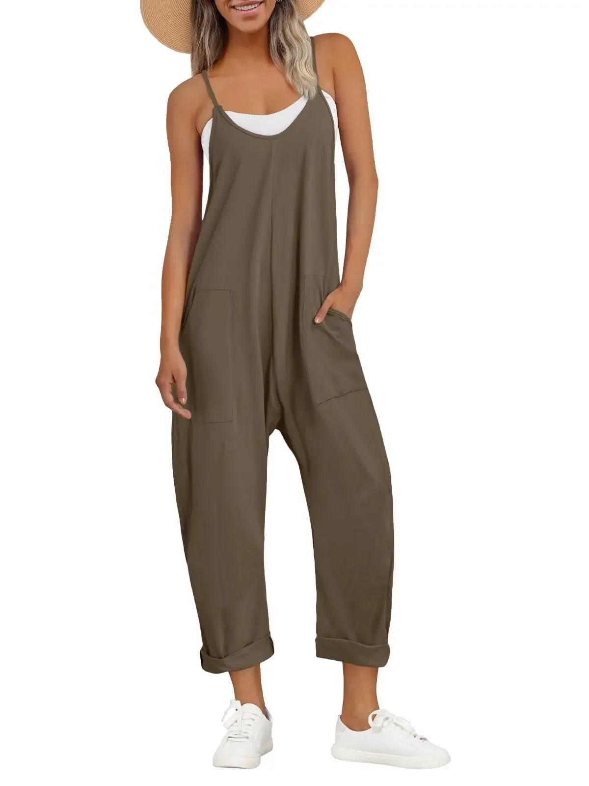 Olive green women's sleeveless jumpsuit with pockets, paired with white sneakers and straw hat