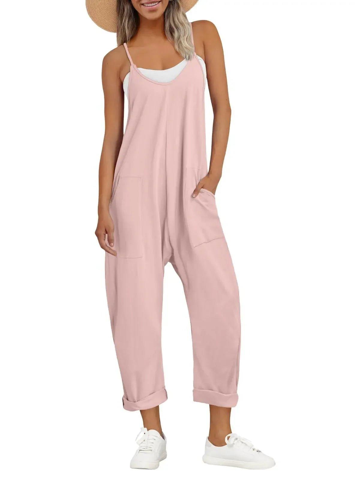 Pink women's jumpsuit with pockets, white sneakers, straw hat — casual summer fashion