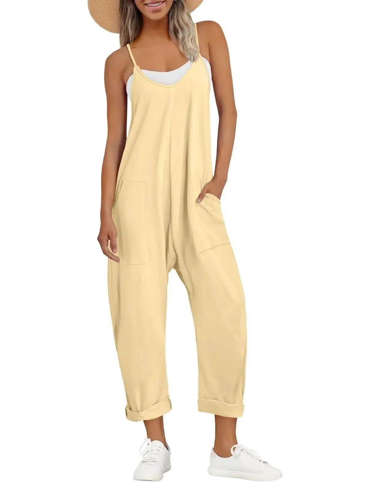 Yellow women's jumpsuit with pockets, paired with white sneakers and straw hat for summer fashion