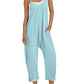 Light blue women's jumpsuit with pockets, straw hat, white sneakers — casual summer fashion