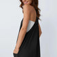 Woman in black backless dress with white lining, stylish fashion outfit
