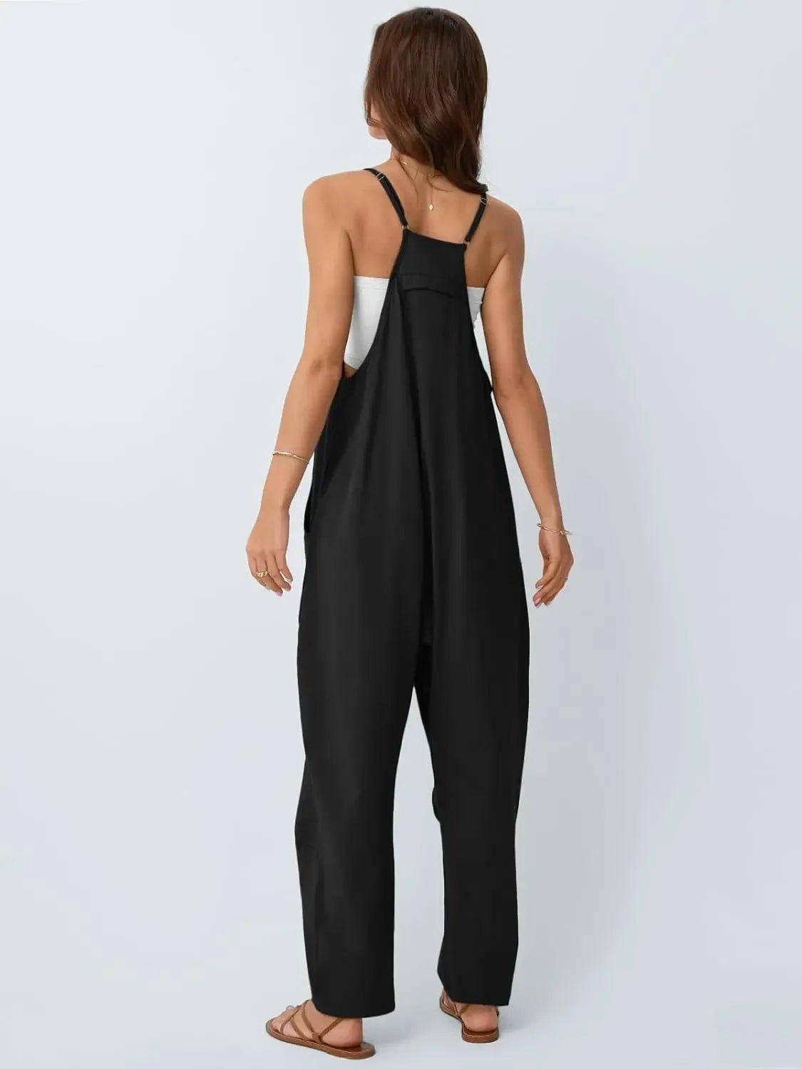 Black women's jumpsuit with thin straps, back view, paired with white top and sandals