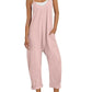 Pink women's jumpsuit with pockets, straw hat, and white sneakers for casual fashion