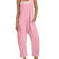 Pink women's jumpsuit with pockets, white sneakers, straw hat — casual summer fashion