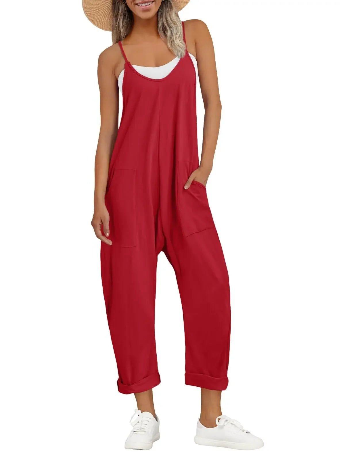 Red women's jumpsuit with pockets, paired with white sneakers and straw hat for casual summer fashion