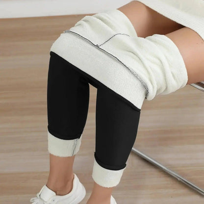 Black fleece-lined leggings with white cuffs, paired with white sneakers for cozy fashion.