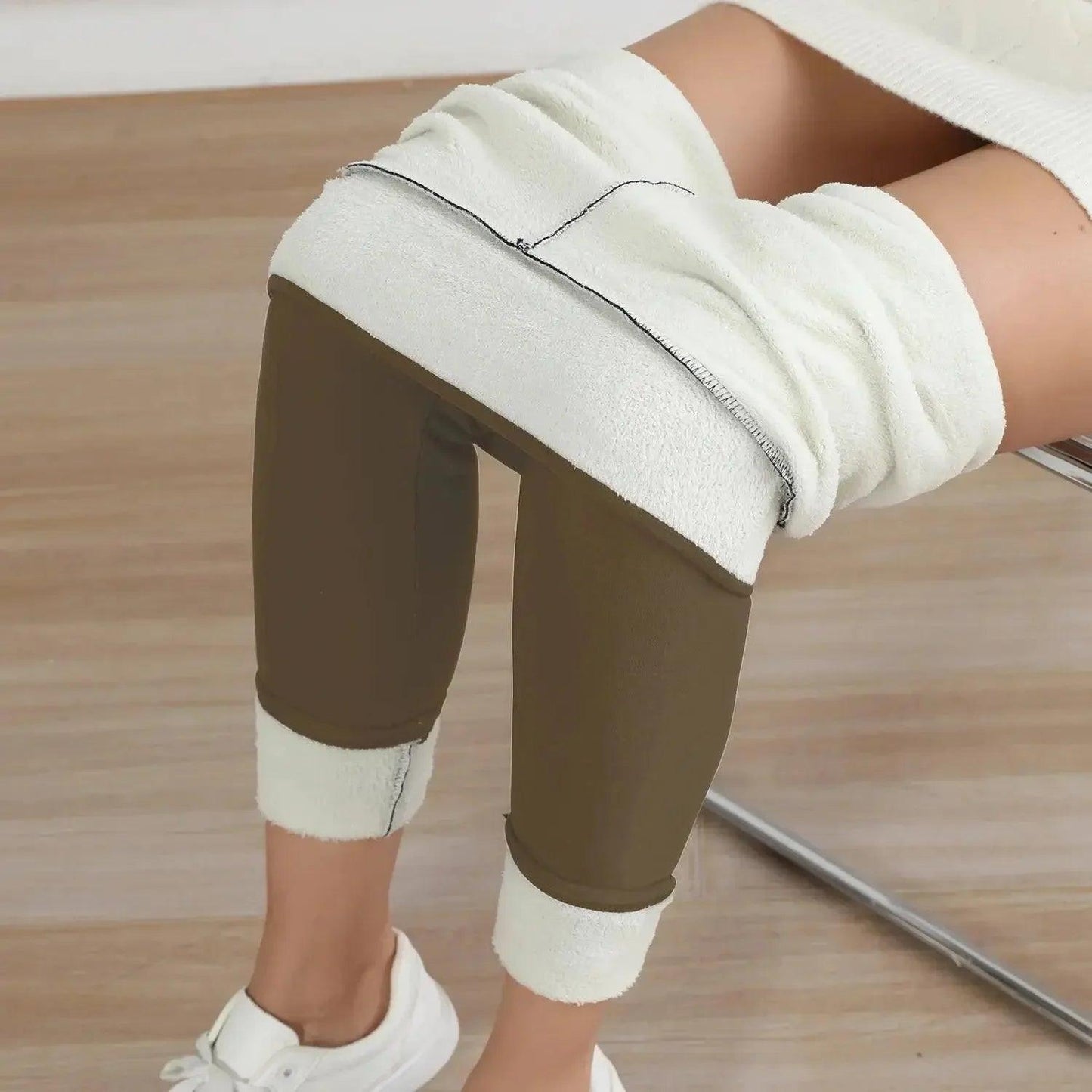 Olive green fleece-lined leggings with white cuffs, paired with white sneakers for cozy fashion.