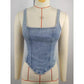 Women's denim corset top with square neckline, fitted waist, and adjustable straps on mannequin