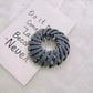 Gray spiral hair clip for women's fashion, stylish hair accessory on quote card
