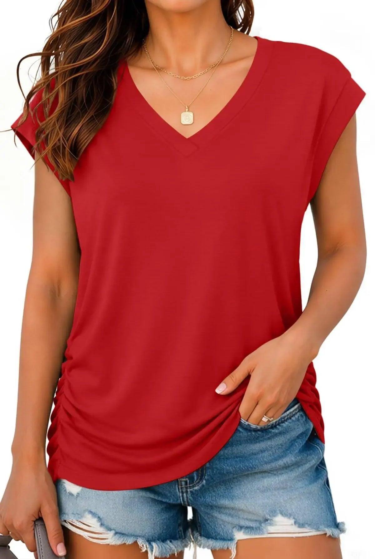 Red V-neck women's t-shirt with ruched side, paired with distressed denim shorts for casual fashion
