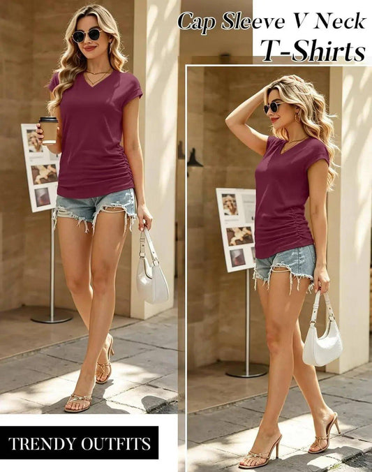 Woman in burgundy cap sleeve V-neck t-shirt with denim shorts, stylish summer outfit