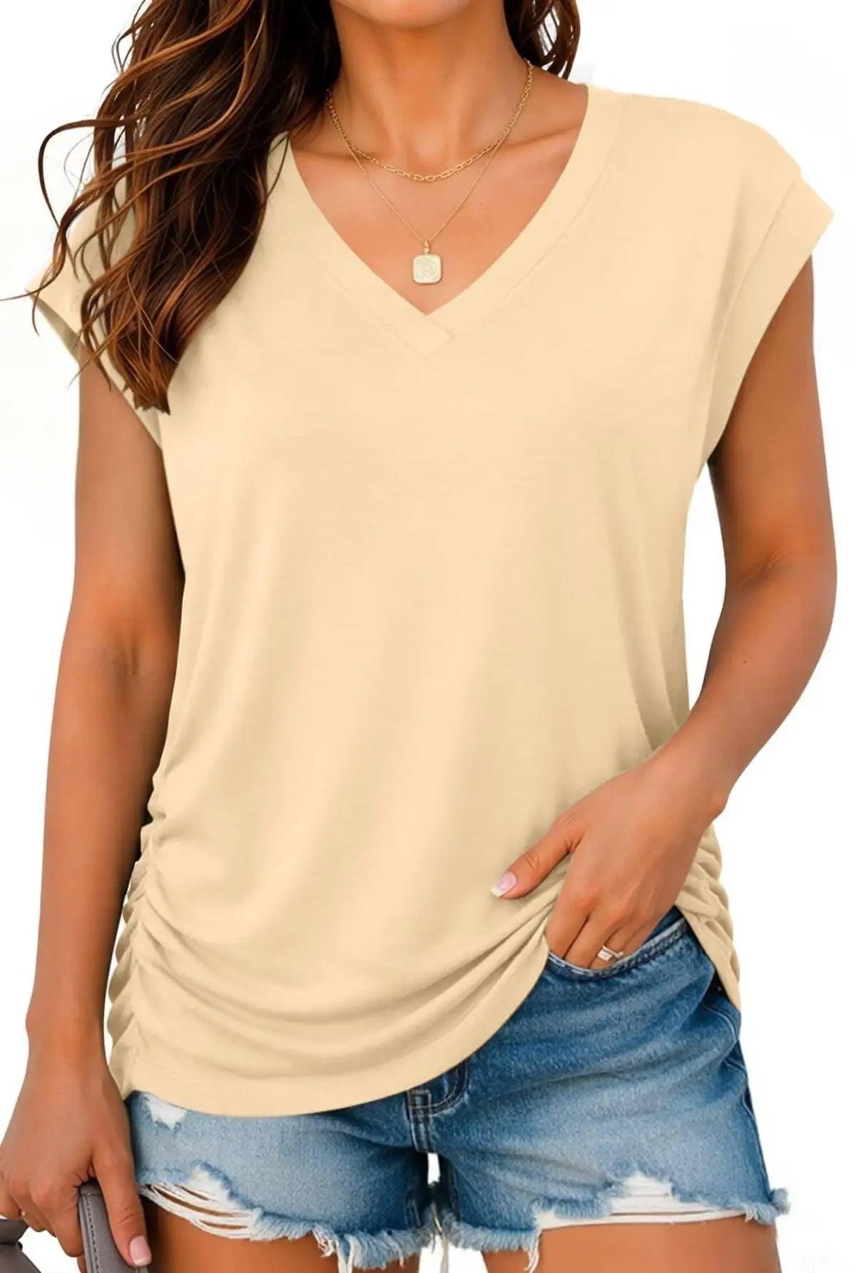 Beige V-neck women's fashion top with ruched side, paired with denim shorts for casual summer style