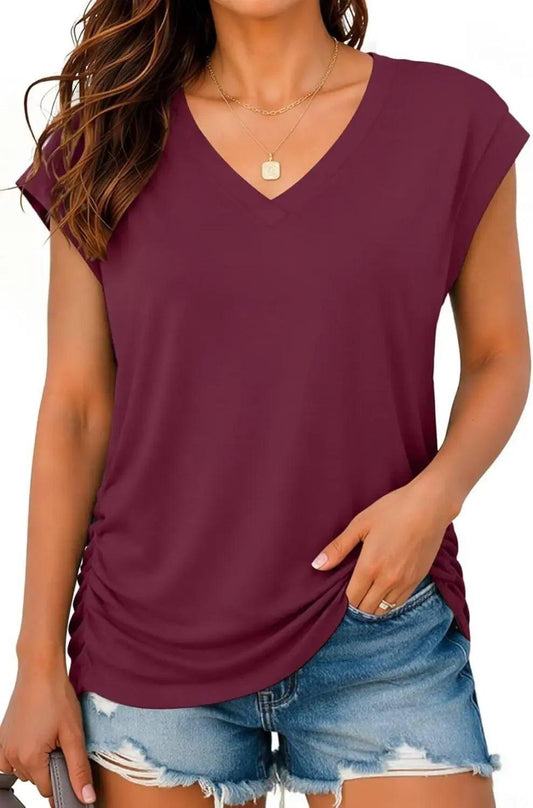 Burgundy V-neck women's t-shirt with ruched side, paired with denim shorts for casual fashion