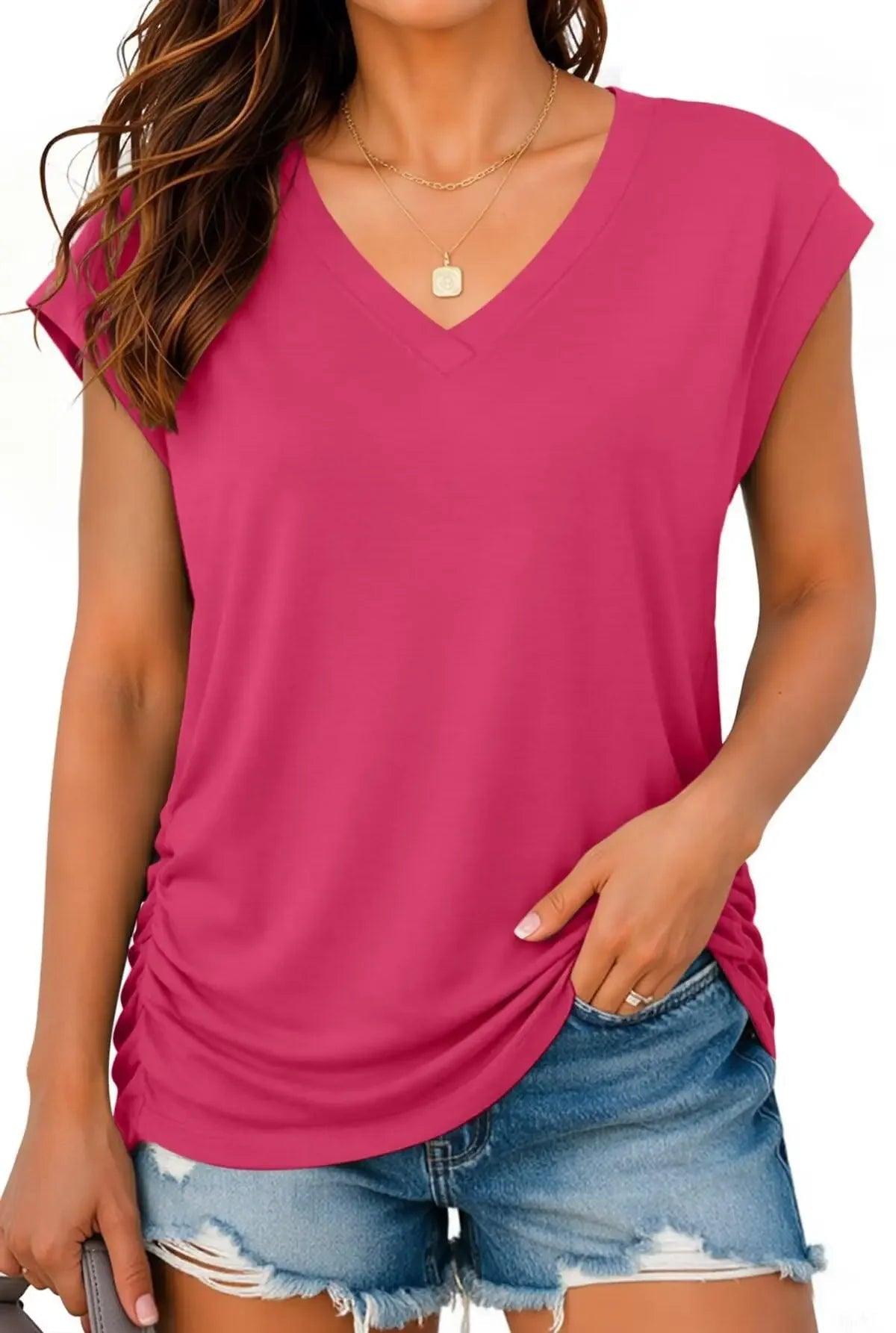 Pink V-neck women's fashion top with ruched side, paired with denim shorts for casual summer style