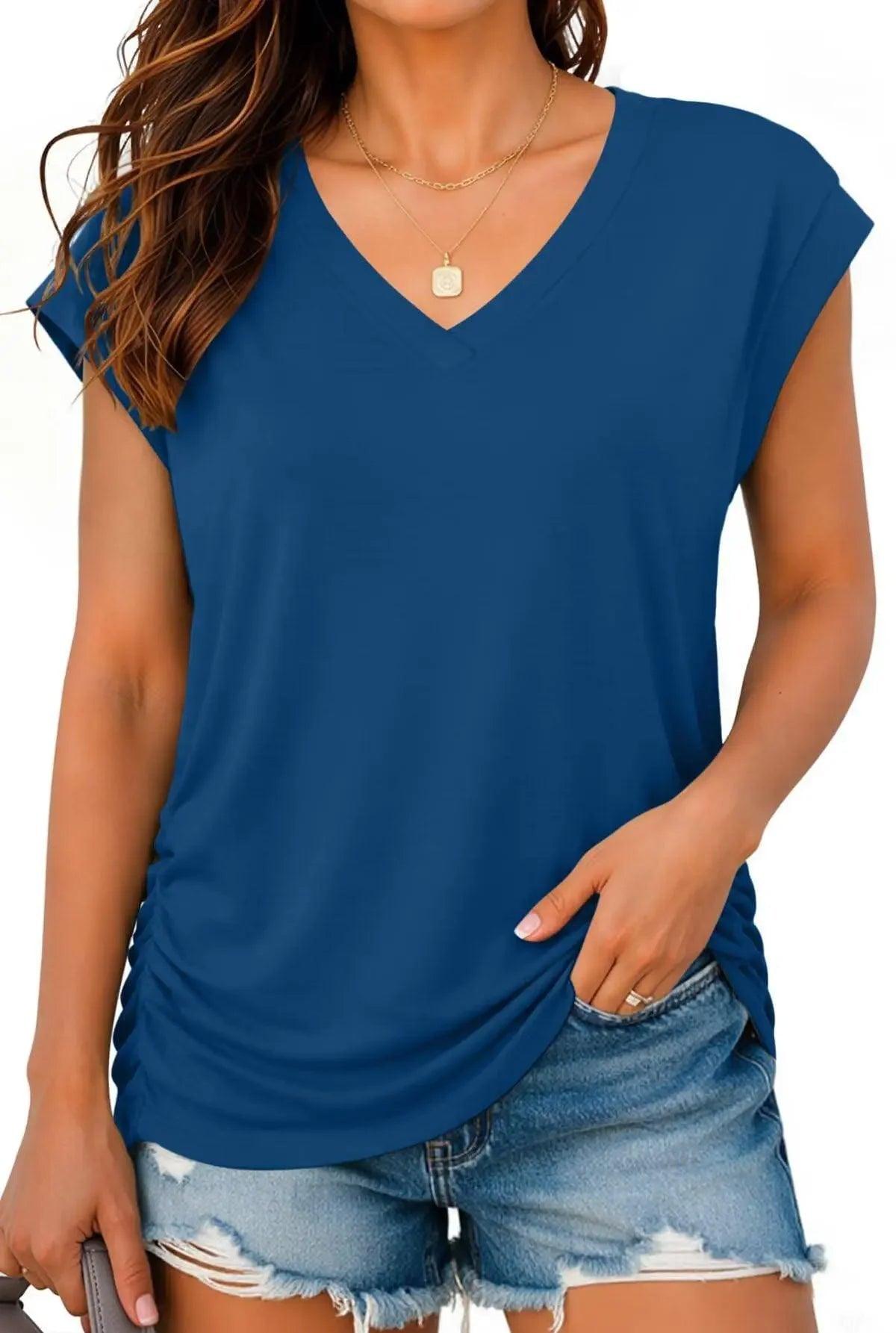 Woman wearing blue V-neck short sleeve top with denim shorts, casual summer fashion