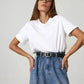 Woman in white t-shirt and high-waist denim jeans with black belt, fashion outfit