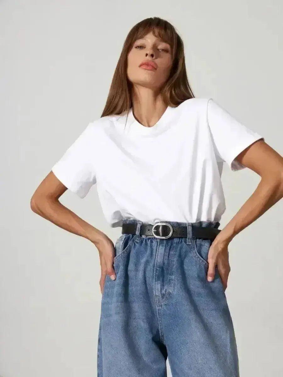 Woman in white t-shirt and high-waist denim jeans with black belt, fashion outfit
